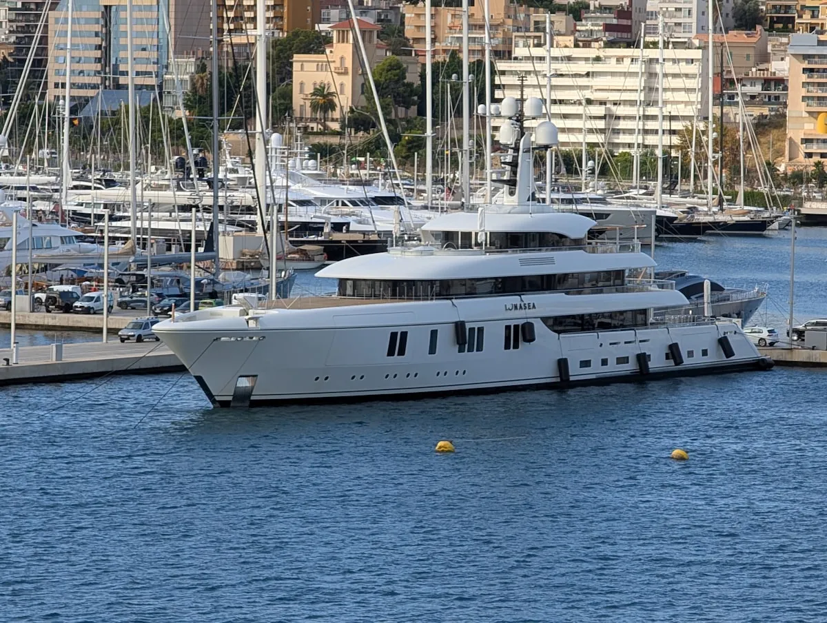 Large white luxury yacht docked in a marina